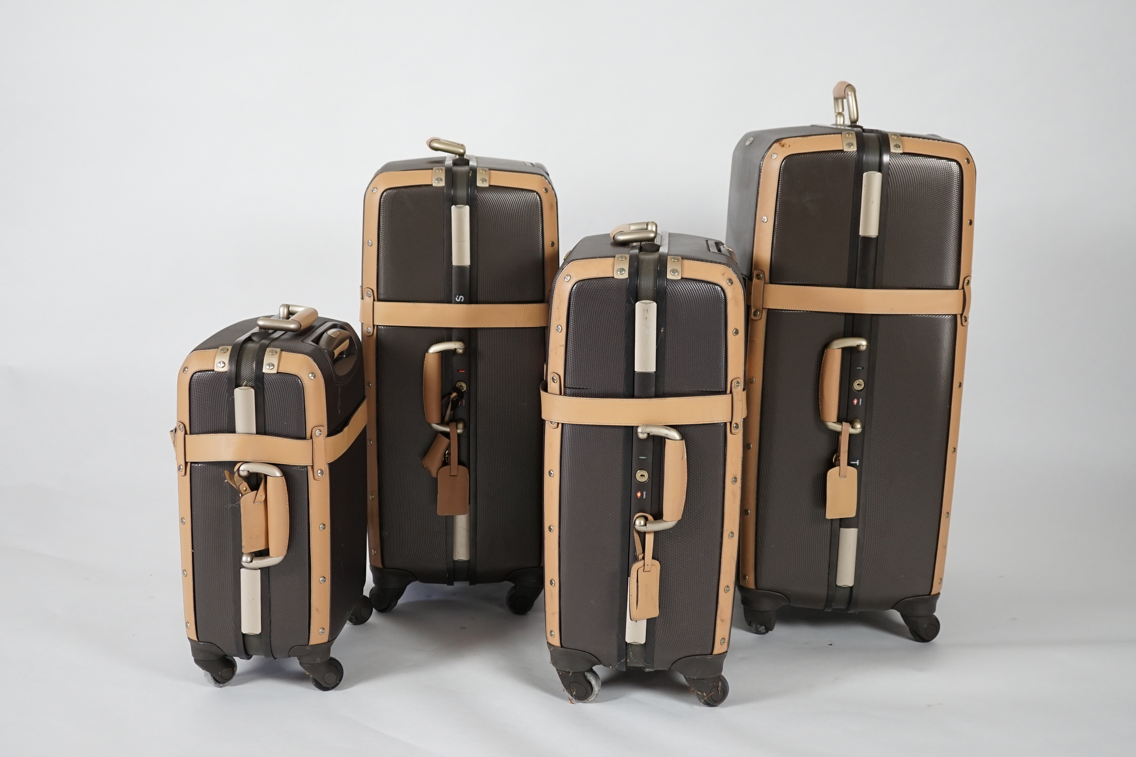 A graduated set of four Samsonite Black Label brown and tan hard suitcases, 83cm x 52cm x 34cm, 77cm x 48cm x 30cm, 66cm x 43cm x 27cm, 53cm x 36cm x 22cm